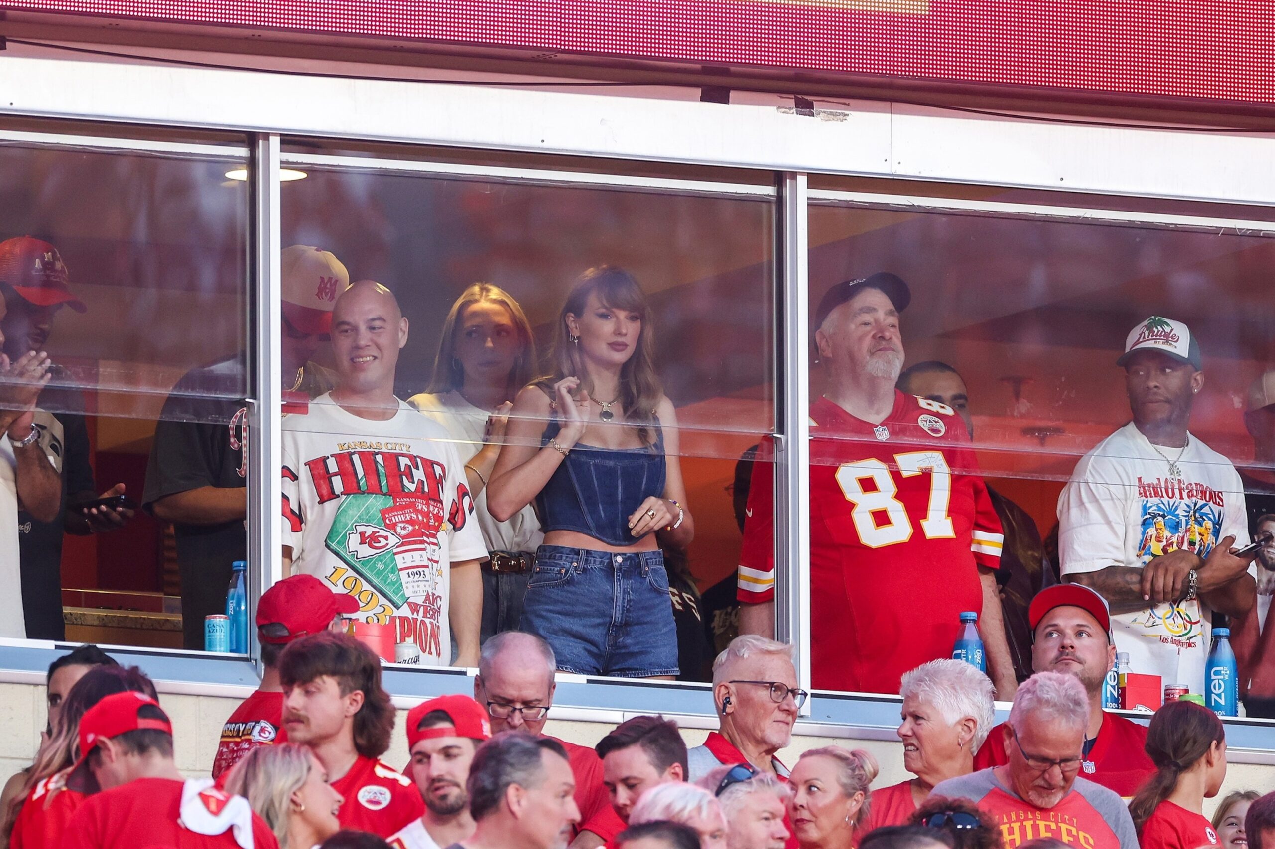 Taylor Swift arrived late to the Browns vs. Chiefs game, unaware that Travis Kelce had a surprise waiting. After the Chiefs' victory, Kelce proposed in front of her parents and cheering fans. Swift, emotional, said "Yes!" as the crowd erupted.